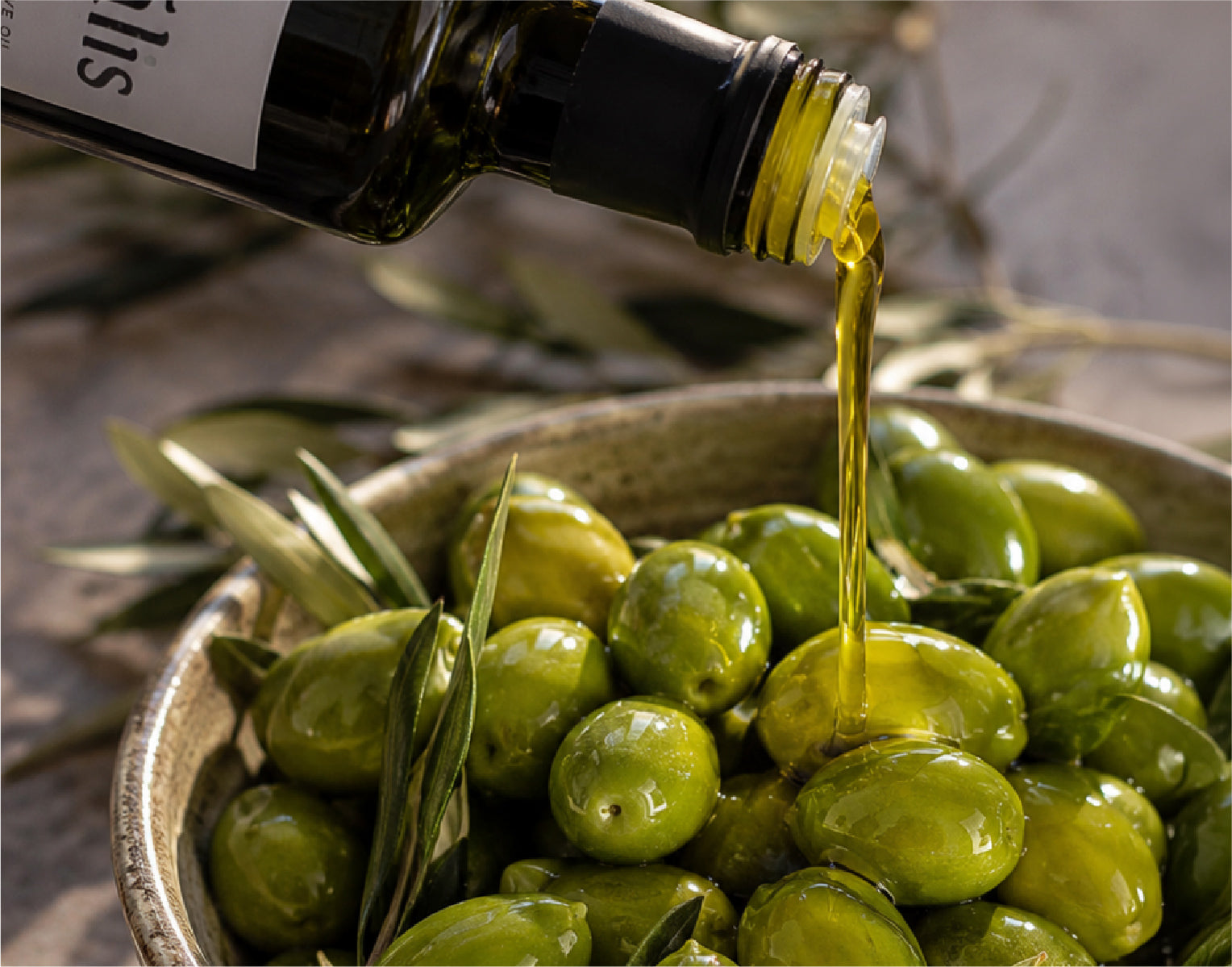 High polyphenol Chetoui extra virgin olive oil poured over fresh Tunisian olives